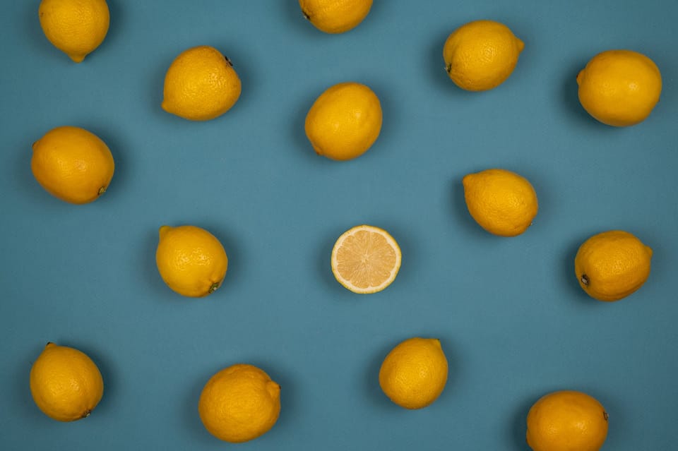 fresh lemons with juicy flesh on blue background